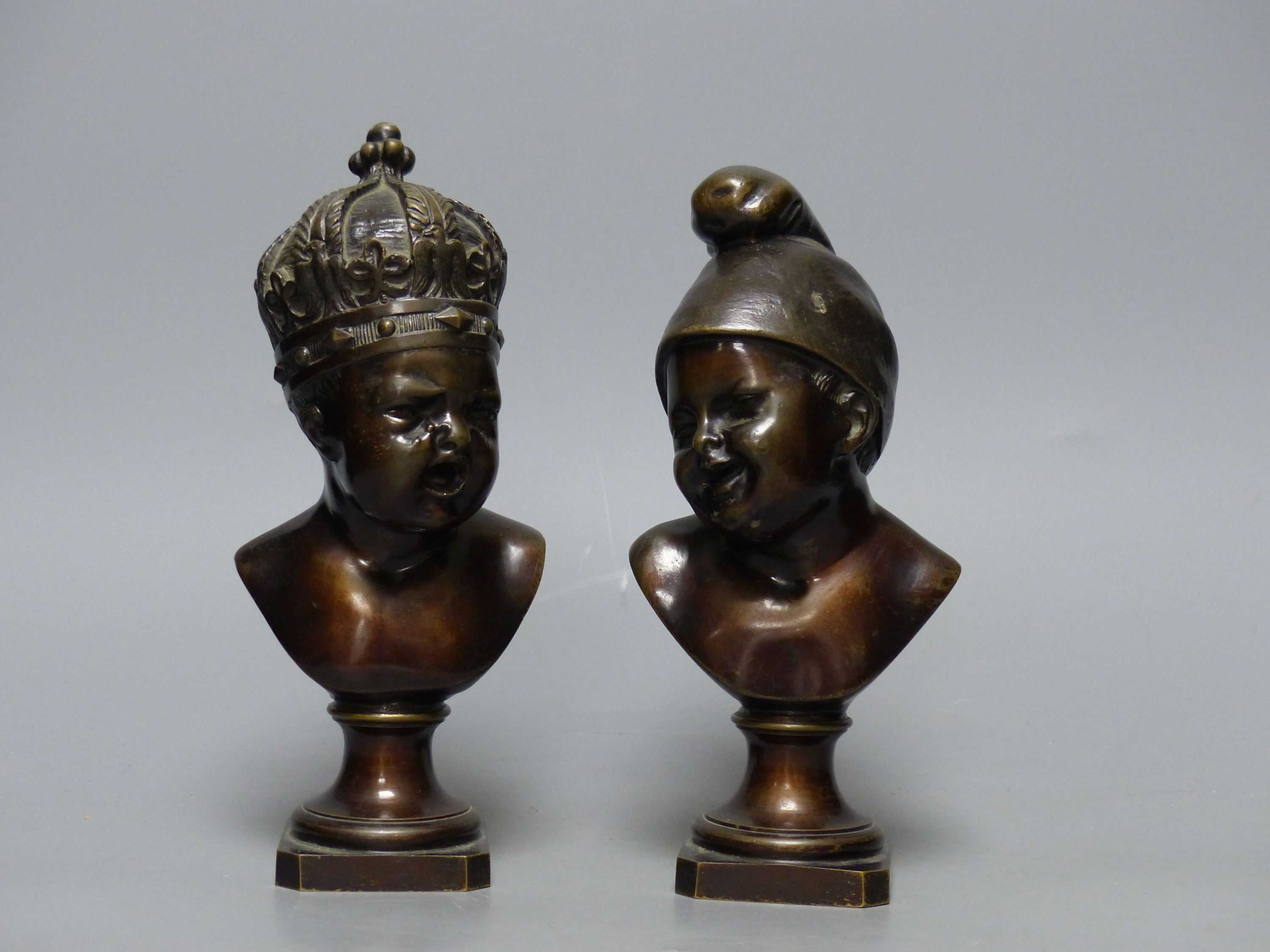 A small bronze bust of a child wearing a crown and another small bronze bust of a child, tallest 22cm H 22cm